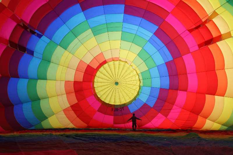 
A rainbow colored hot air balloon being inflated - jigsaw puzzle