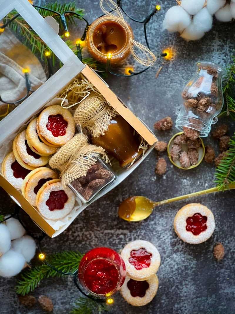 a box filled with cookies next to a christmas tree - jigsaw puzzle