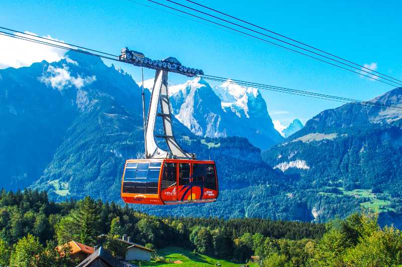 A breathtaking view of a cable car traversing the stunning Swiss Alps