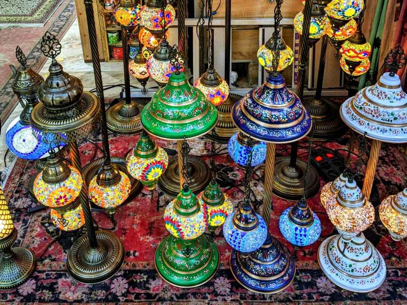 A display of colorful lamps on a rug