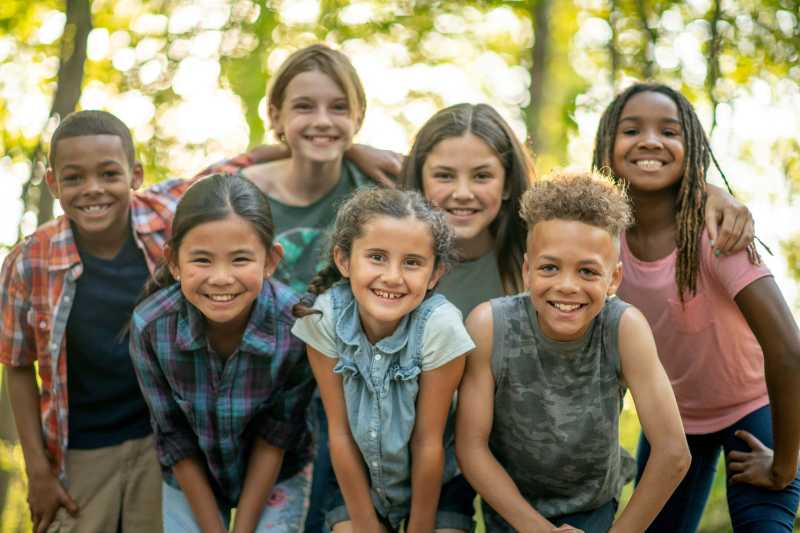 a group of children huddle together outside for a portrait - jigsaw puzzle