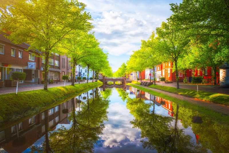 a river running through a lush green park - jigsaw puzzle