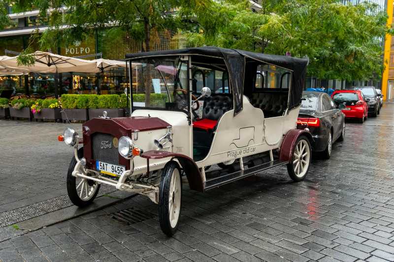 A White and Brown Vintage Car on Gray Pavement