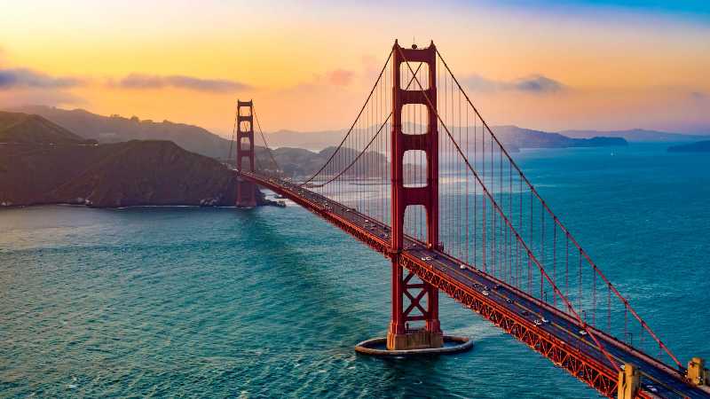 Aerial view of traffic moving on golden gate bridge during sunset san francisco california usa