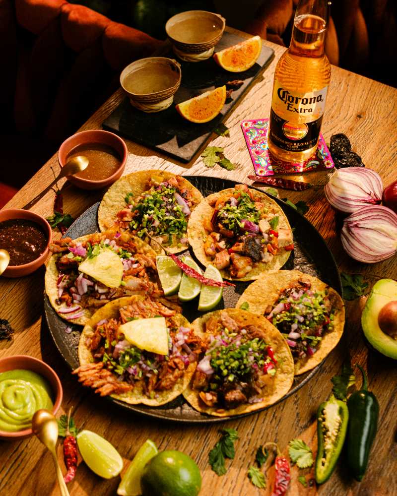 a table topped with tacos and a bottle of beer - jigsaw puzzle