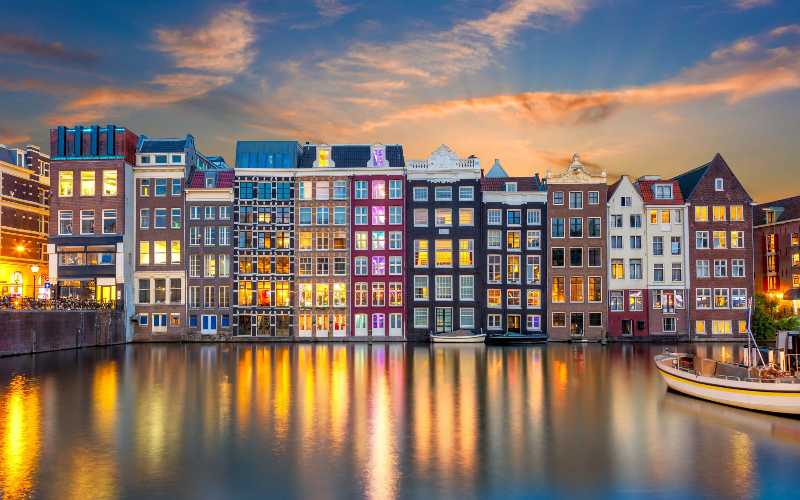 Amsterdam Canal Houses at Sunset with Reflection in Water