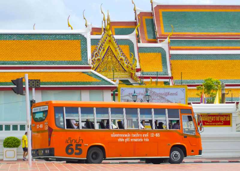 An Orange Bus on a Road