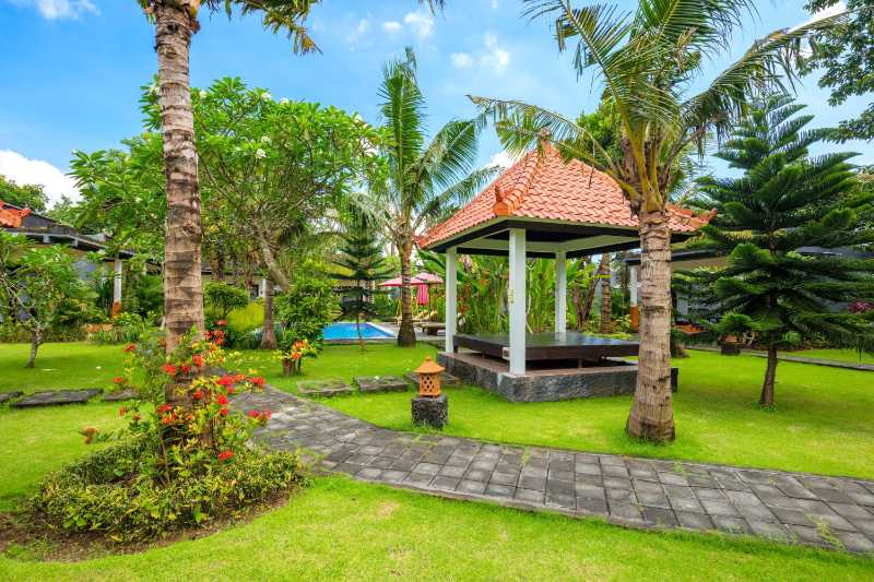 Beautiful tropical garden with swimming pool palm trees and flowers island tropical resort