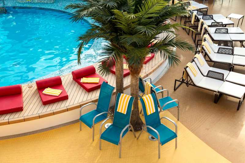 Blue and white lounge chairs near swimming pool