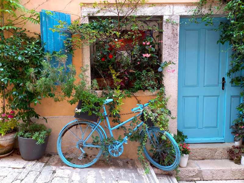 Blue bicycle decoration in front of a building exterior