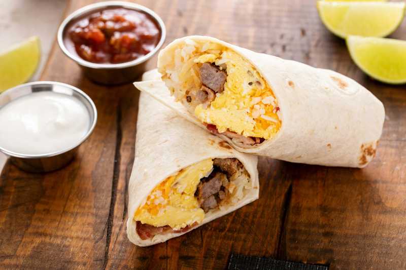 breakfast burrito with sausage scrambled eggs hashbrown potatoes and cheese - jigsaw puzzle