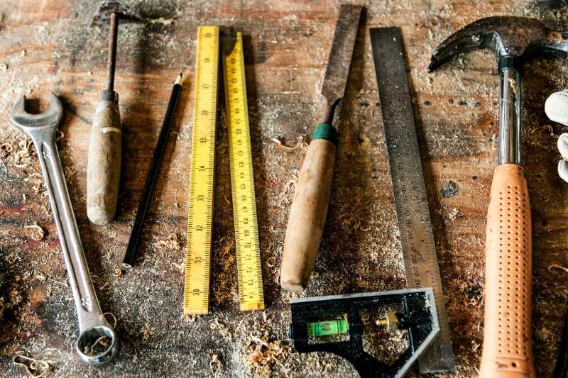 Carpenter's Tools on a Dusty Wooden Workbench
