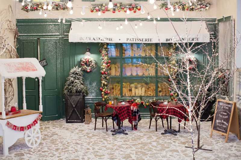 Christmas cafe bakery exterior with christmas decorations and fresh bread in glass showcase