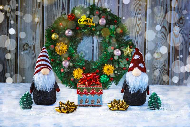 Christmas elves with gift boxes gold ribbon christmas wreath and trees