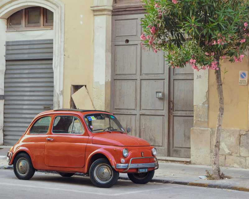 Klassischer orangefarbener Fiat 500 auf der Straße geparkt