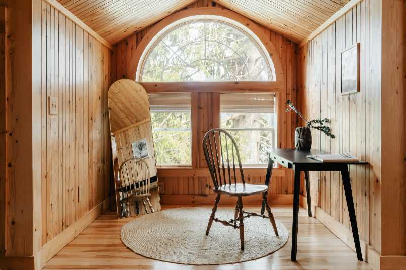 a room with a chair a table and a window - jigsaw puzzle