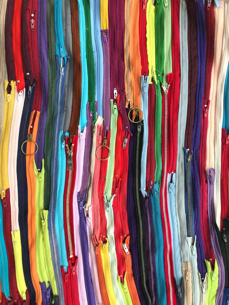 Close-up of Variety of Zippers in Different Colors
