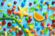 Colorful candies scattered on blue background - jigsaw puzzle