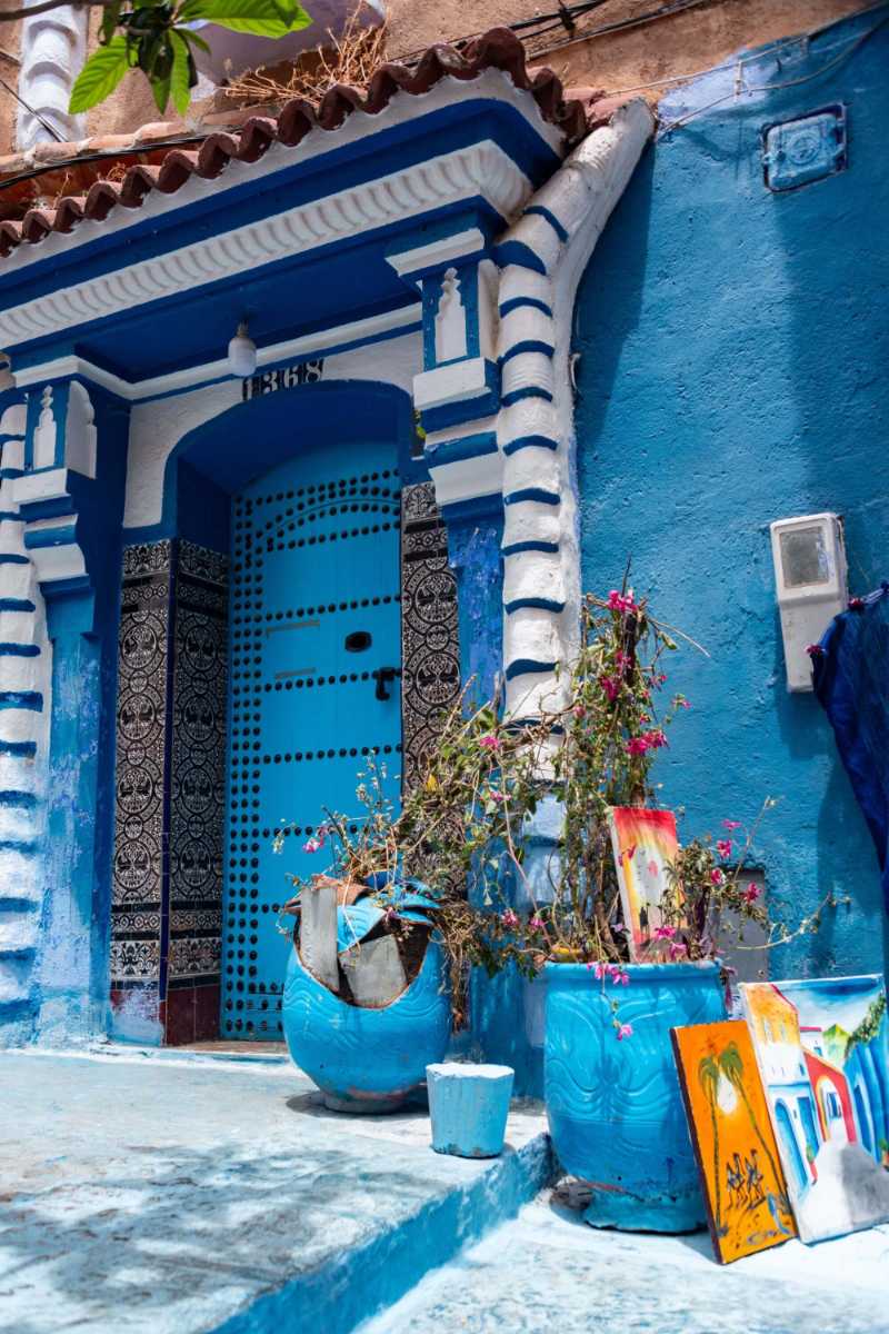 Colorful Moroccan alleyway with blue hues and artistic details