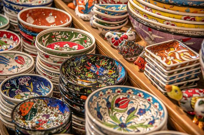 colorful patterned bowls are stacked for display