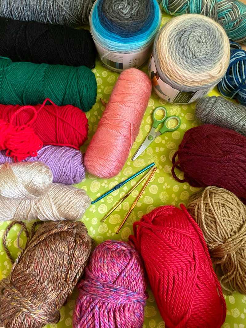 Colorful yarn balls and crochet hook