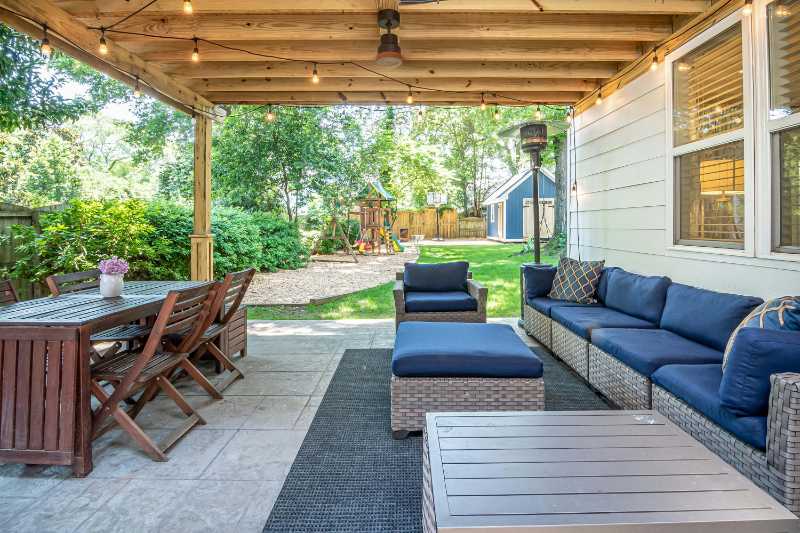 Cozy Outdoor Wicker Sofa and Dining Set on Covered Patio