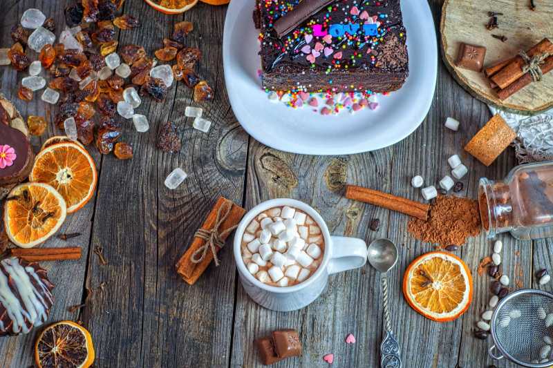 Cozy Winter Flat Lay Hot Chocolate with Marshmallows Chocolate Cake and Cinnamon