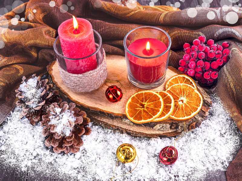 Cozy Winter Table Decor with Red Candles and Pinecones in Snow