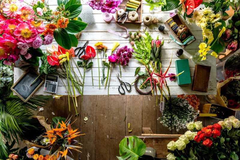 Florist Workbench Overhead View with Flowers and Tools