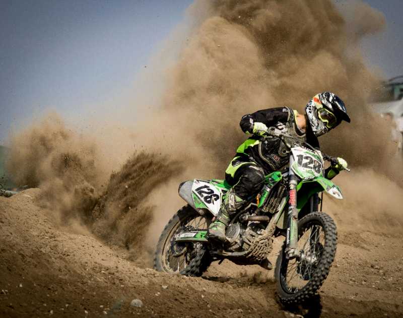 rider riding green motocross dirt bike - jigsaw puzzle