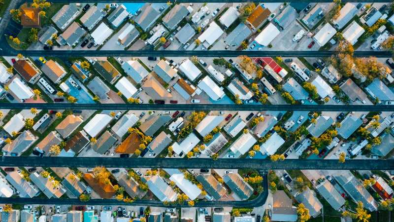 Drone view of residential complex and highways in daylight