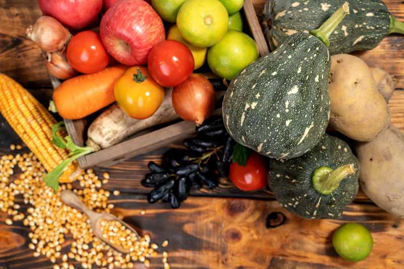 Fall harvest and autumn season with organic fruit and vegetable on wood background