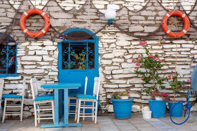 Front view of beach cafe exterior table and empty chairs outdoor near the stone wall typical mediterranean restaurant a place holidays in the summer bodrum turkey