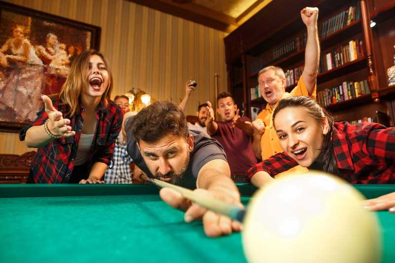 Group of Friends Playing Billiards
