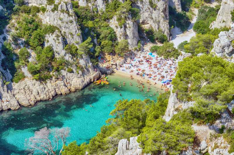 high angle view rocks by sea against trees