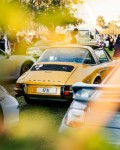 a group of cars parked next to each other on a field - jigsaw puzzle