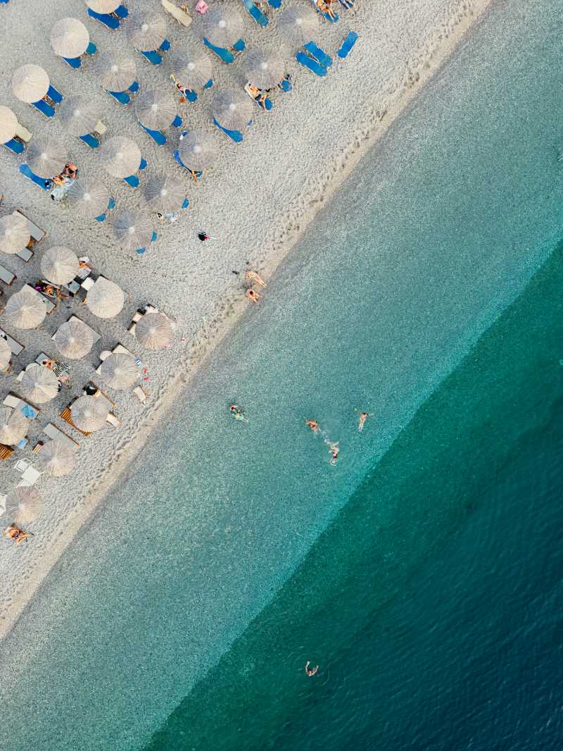 an aerial view of a beach with umbrellas and chairs - jigsaw puzzle