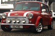 a small red car parked in a parking lot - jigsaw puzzle