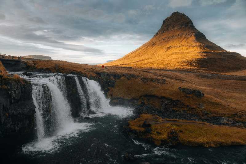 a waterfall with a mountain in the background - jigsaw puzzle