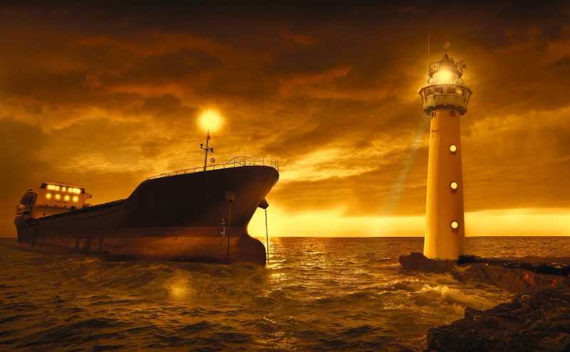 Lighthouse and Freighter at Sunset Dramatic Golden Seascape