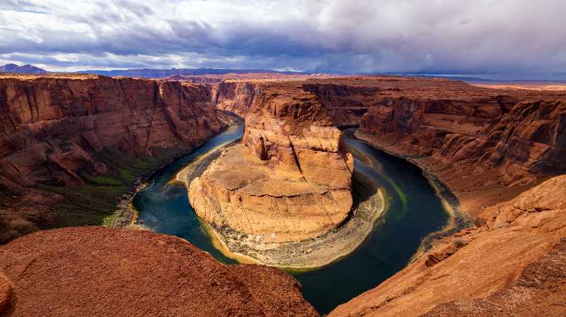 a river flowing through a canyon surrounded by mountains - jigsaw puzzle