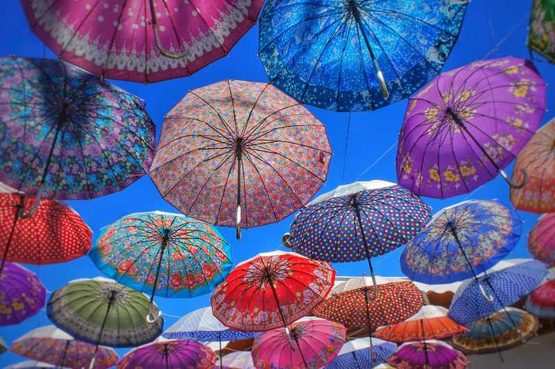 Multi colored umbrellas hanging at market stall