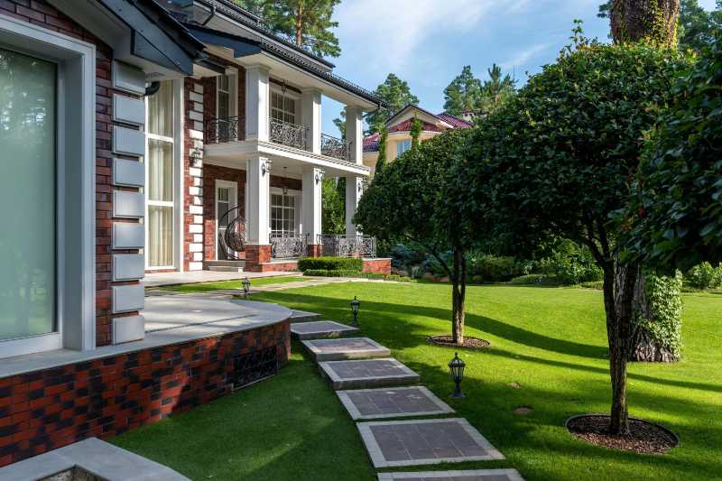 Luxurious Brick House with Manicured Lawn and Stone Pathway