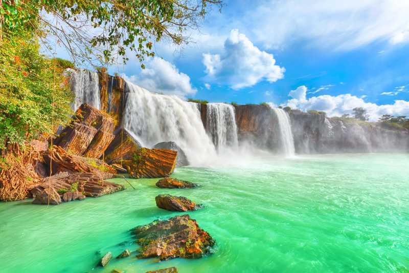 Majestic Waterfall Plunge into Emerald Green Pool