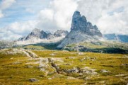 rock formation on wide field grass under cloudy blue sky during daytime - jigsaw puzzle