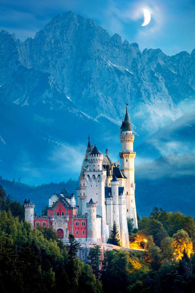 Neuschwanstein Castle at night with moon