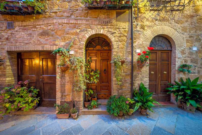 Night view of street in small mediterranean town with old houses doors and flowers