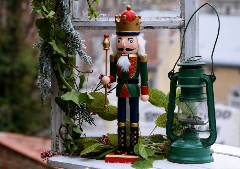 green red and brown nutcracker beside green lantern and plant - jigsaw puzzle