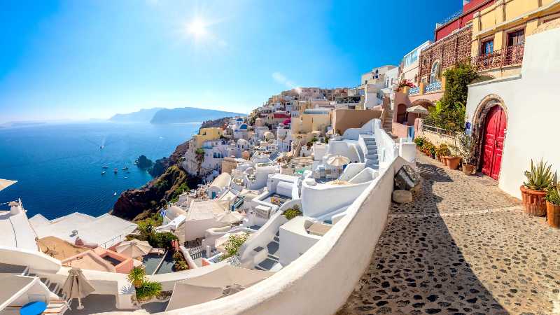 A panoramic view of the traditional santorini cycladic houses on a small street oia village santorini greec