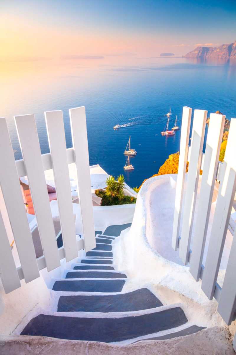 Open gate and steps to the blue sea of santorini